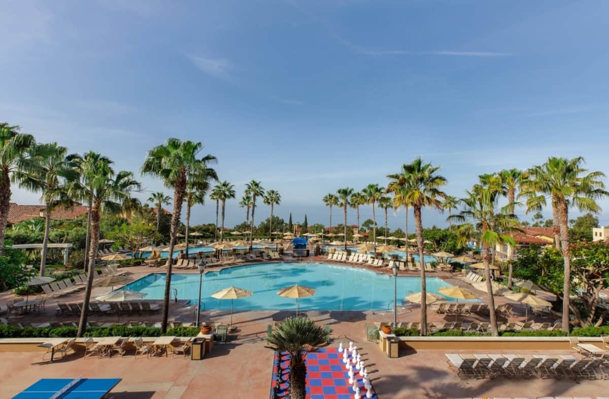 Newport Coast Villas pool deck with palm trees and the ocean beyond